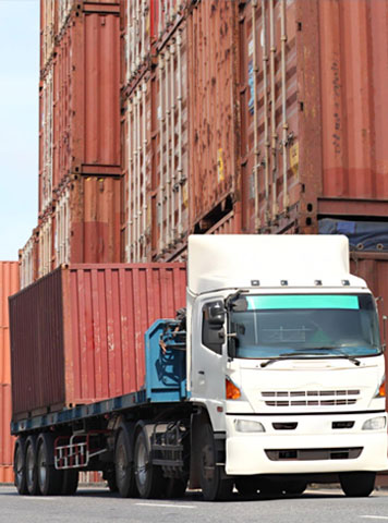 Workers loading a couch onto a moving truck